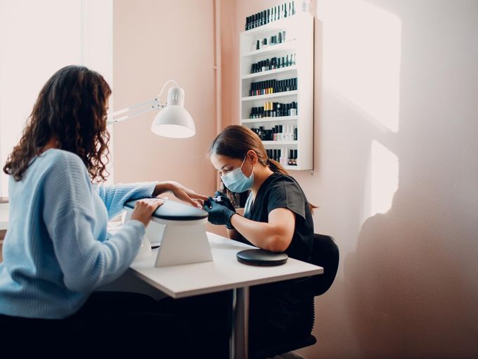 Professional nail technician workspace with nail care supplies
