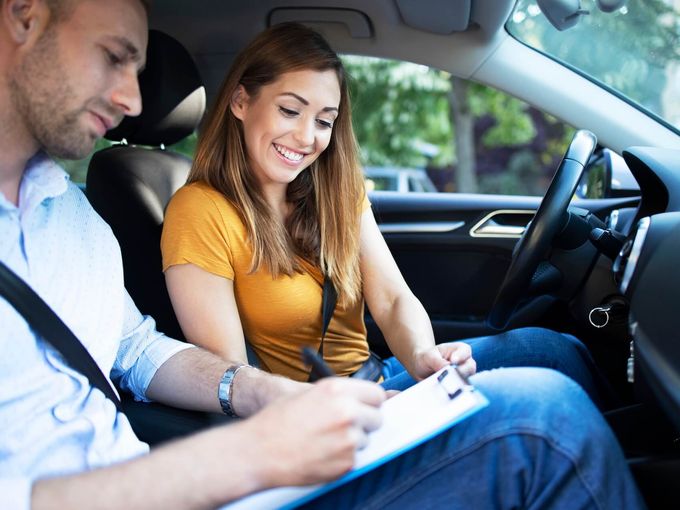 Driving instructor with student in car
