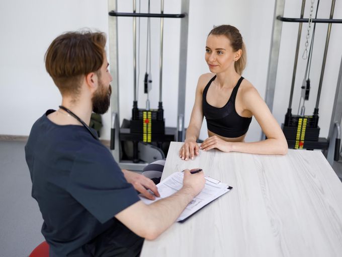 Personal trainer working with client in fitness setting