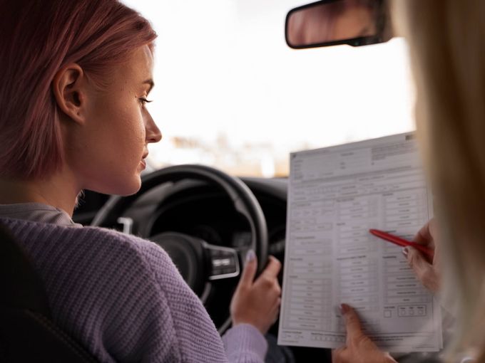Driving instructor with student in car